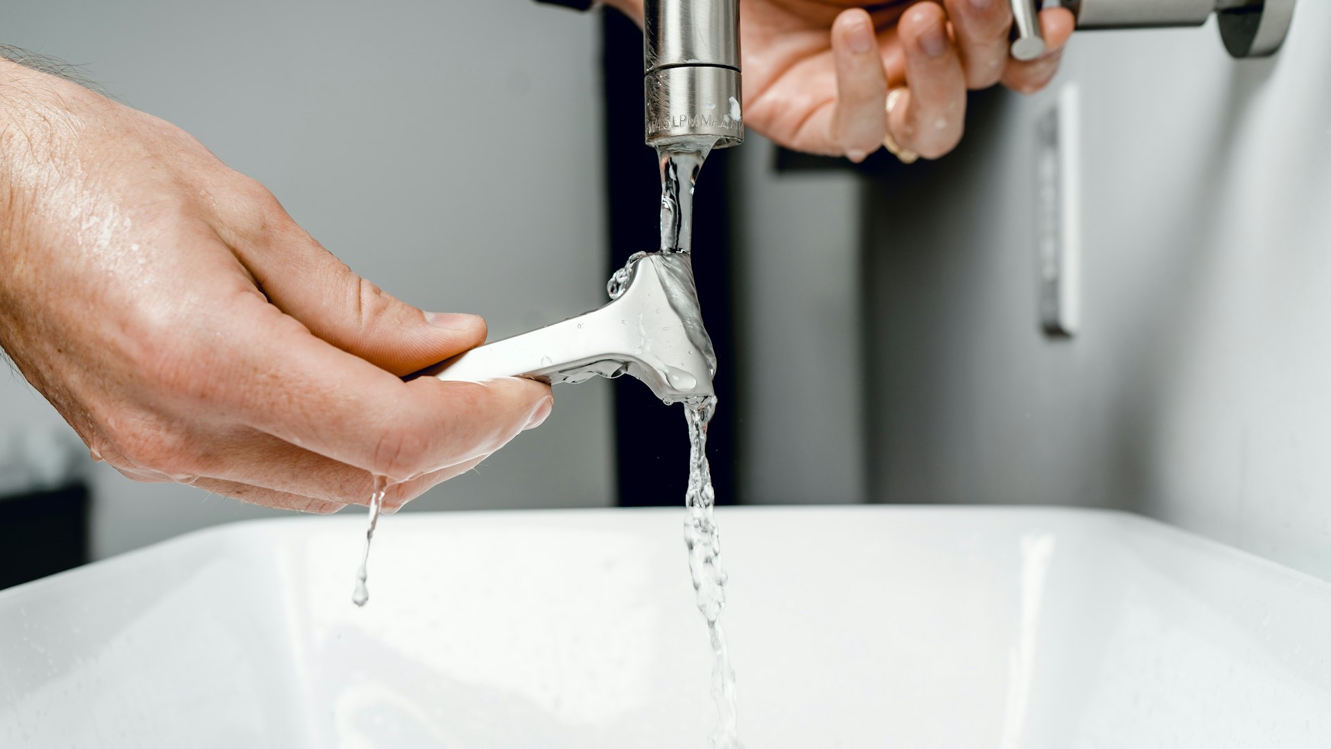 Water running from a faucet into a sink