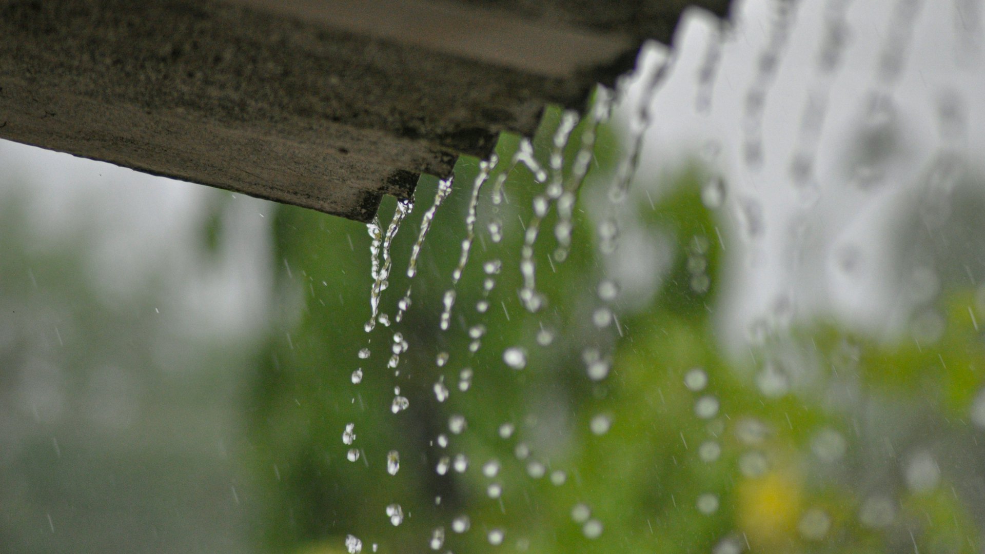 Rain running out of a gutter at the roof edge